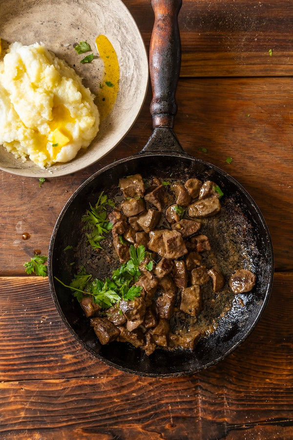 Venison in a pan with mashed potato